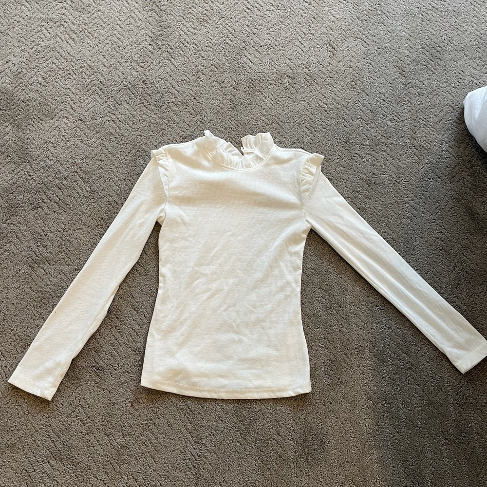White long sleeved shirt with ruffle detail